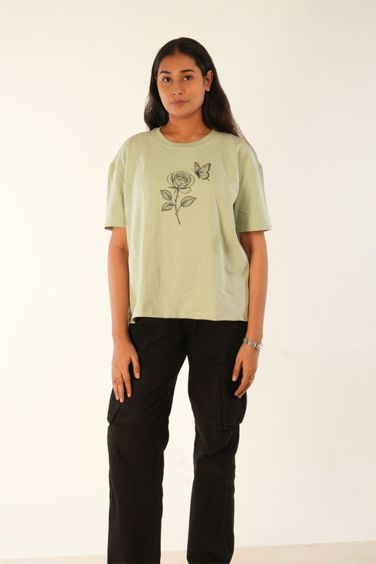 Sage green oversized t-shirt with hand-drawn rose and butterfly graphic, premium knit fabric, women's streetwear, relaxed fit, Berrys & Cigaredes India