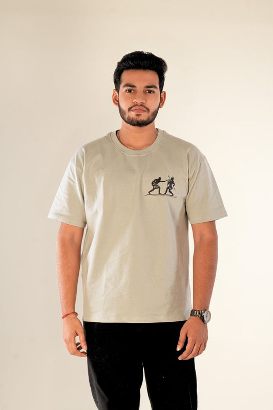 Men's oversized graphic t-shirt in sage grey featuring minimalist line-art warrior fighting illustration on chest. Premium heavy-weight cotton fabric with relaxed drop-shoulder silhouette. Berrys & Cigaredes authentic Indian premium streetwear
Sage grey oversized t-shirt with minimalist warrior graphic chest print