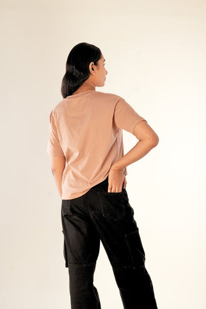 Back view of women's nude brown t-shirt showing minimalist design and premium cotton fabric quality