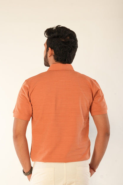 Back view of orange textured piqué polo shirt by Berrys & Cigaredes. Premium cotton construction, structured fit, clean tailoring. Perfect for casual and smart-casual menswear styling.