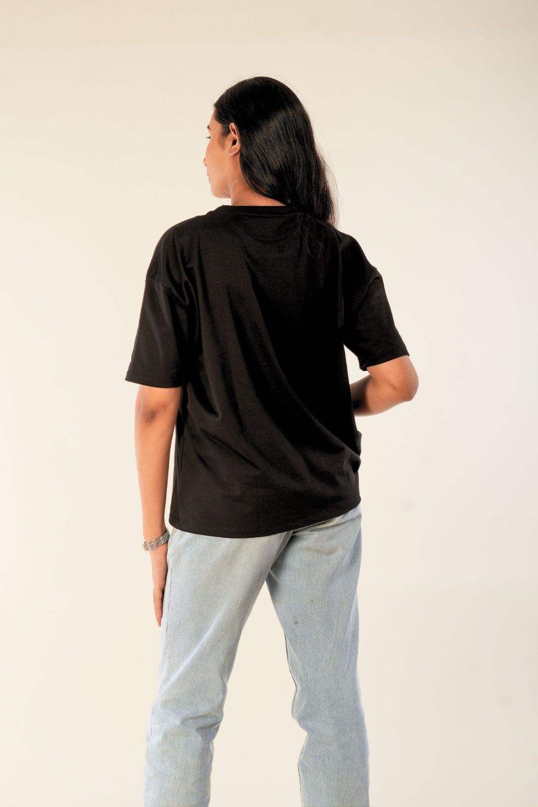 Black oversized women's t-shirt featuring soft touch fabric and minimal aesthetic design. Premium casual streetwear from Berrys & Cigaredes. Shown in back view with relaxed, comfortable fit.