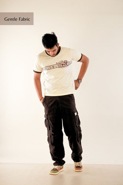 Premium men's graphic t-shirt from Berrys & Cigaredes - cream base with detailed brown heritage print, regular fit, showcasing artistic streetwear design and gentle fabric quality