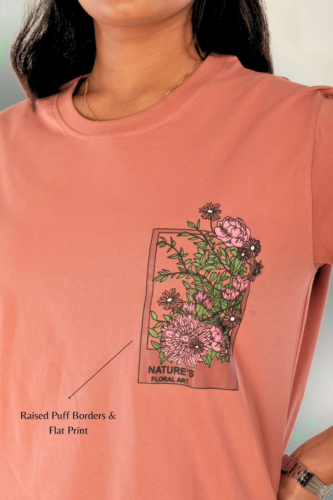 Detail shot of raised puff print border with flat floral garden artwork featuring 'Nature's Floral Art' text design