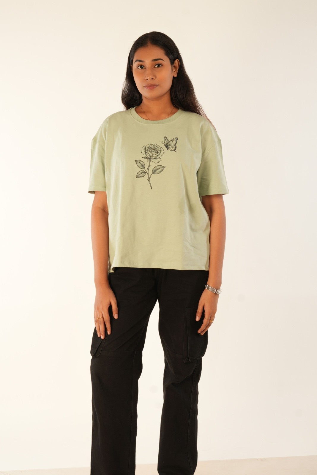 Sage green oversized t-shirt with hand-drawn rose and butterfly graphic, premium knit fabric, women's streetwear, relaxed fit, Berrys & Cigaredes India
