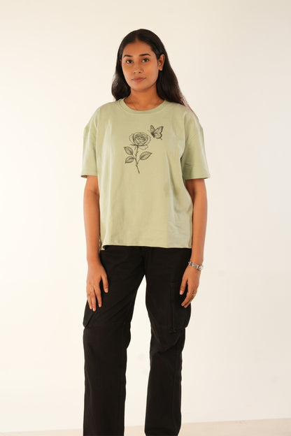 Sage green oversized t-shirt with hand-drawn rose and butterfly graphic, premium knit fabric, women's streetwear, relaxed fit, Berrys & Cigaredes India