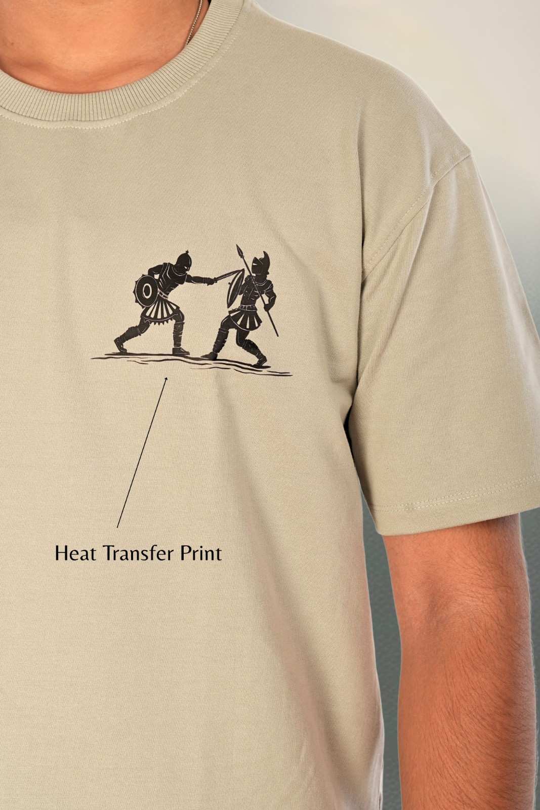 Close-up of heat transfer print detail showing minimalist two-figure warrior fighting illustration with refined line-art aesthetic. Demonstrates premium print quality, color precision, and craftsmanship on sage grey heavyweight cotton. Berrys & Cigaredes design detail.

Minimalist warrior heat transfer print detail on sage grey premium cotton chest