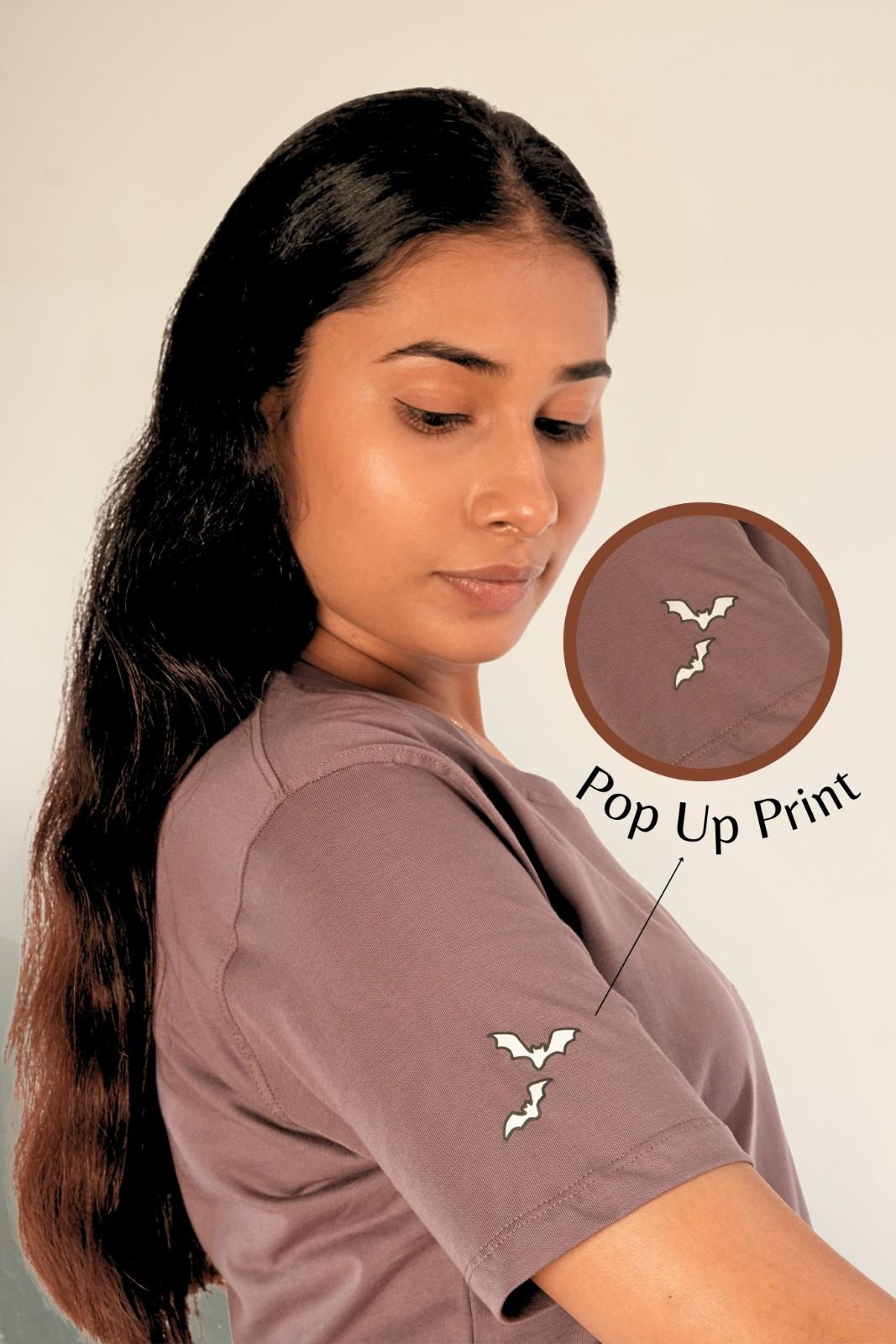Sleeve bat print detail on mauve cotton t-shirt | Pop-up print technique | Berrys & Cigaredes premium women's tee