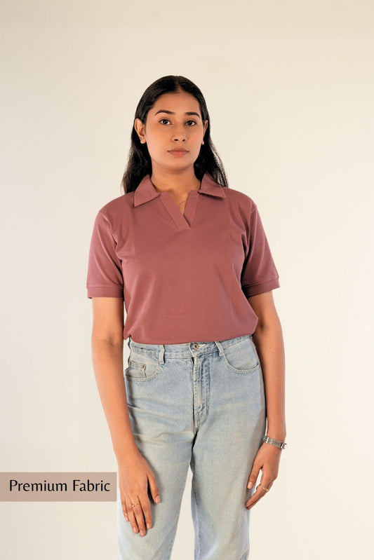 Full-length view of woman in premium dusty rose polo shirt with light jeans, premium fabric designation