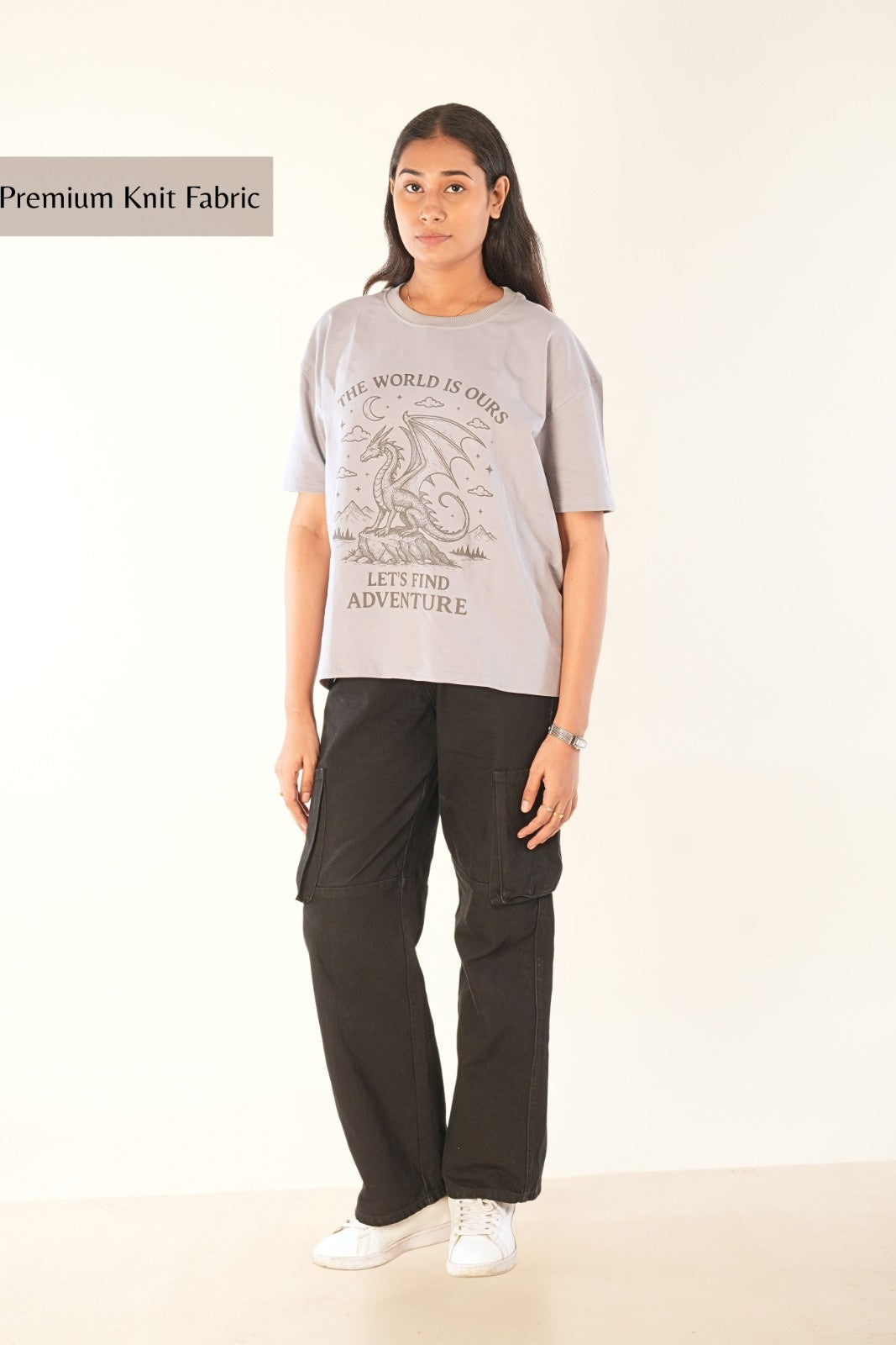 Women's oversized grey graphic t-shirt with fantasy dragon design and adventure text, premium streetwear styling